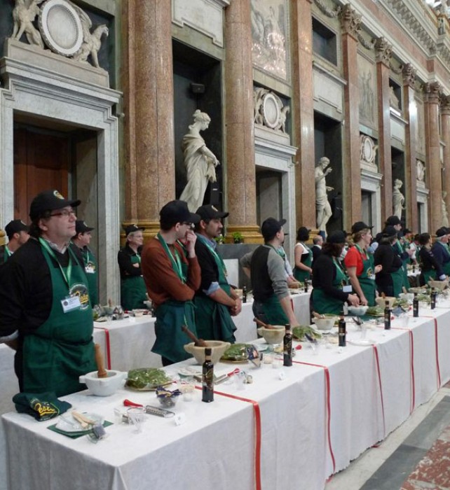 One hundred semi-finalists listen to the pesto hymn, before they begin to pound.