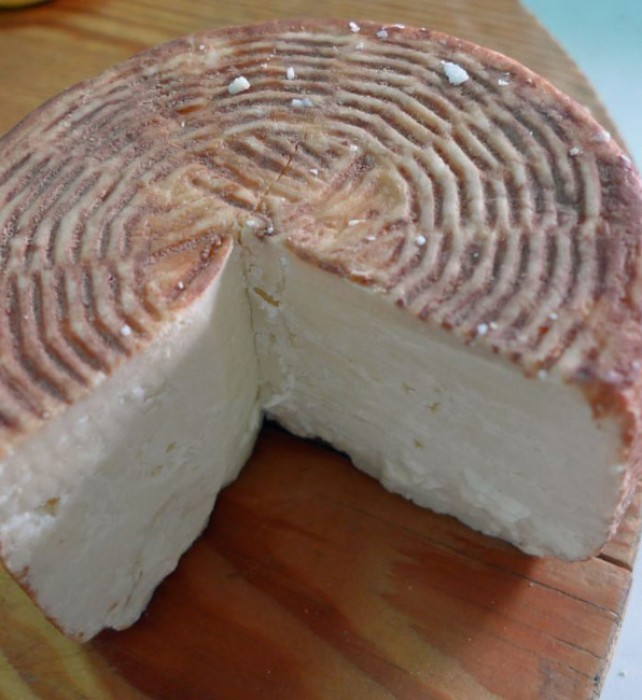 Goat’s cheese which ages in wine dredges.