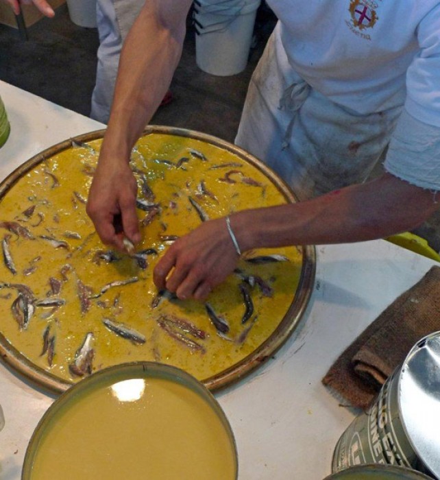 Here, it is topped with fresh anchovies.